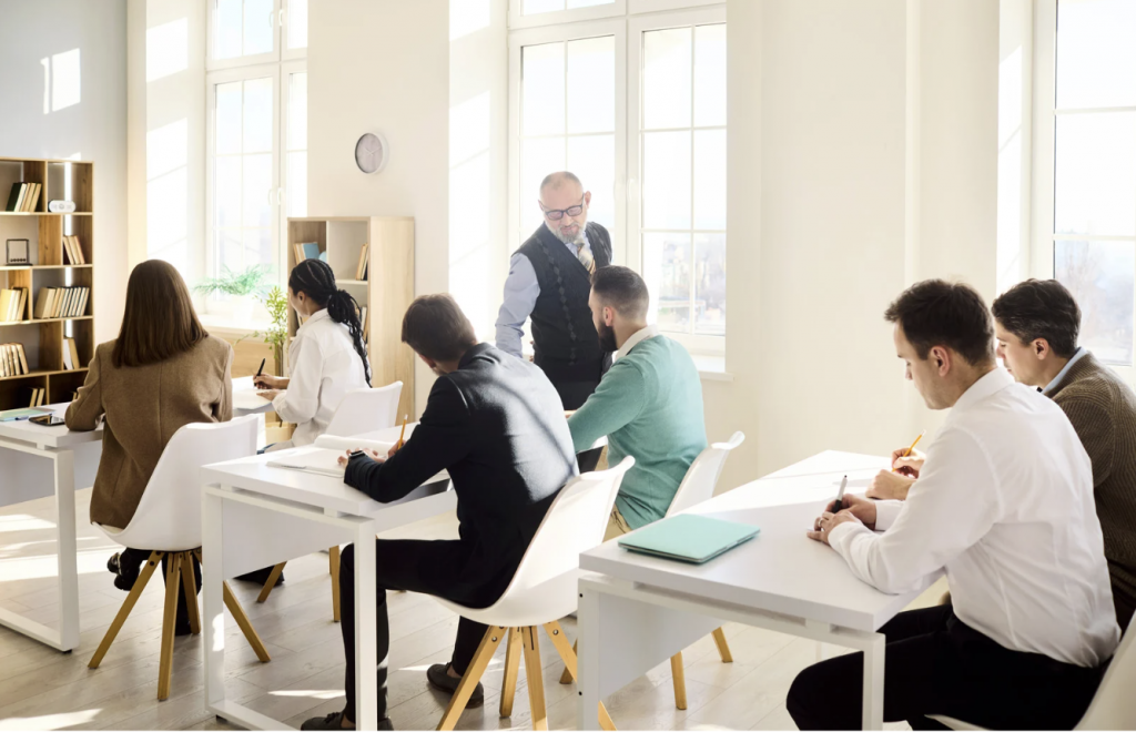 adults learning english in classroom